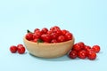 Bowl with fresh red cherry on blue background Royalty Free Stock Photo