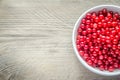 Bowl with fresh redcurrant on the wooden table Royalty Free Stock Photo
