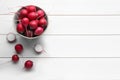 Bowl with fresh ripe radishes on white wooden table, flat lay. Space for text