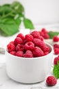 Bowl with fresh ripe raspberries on white marble table, closeup Royalty Free Stock Photo