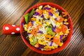 Bowl of fresh salad with vegetables and greens on wooden table Royalty Free Stock Photo