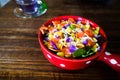 Bowl of fresh salad with vegetables and greens on wooden table Royalty Free Stock Photo