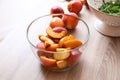 Bowl with fresh sliced peaches on wooden table Royalty Free Stock Photo