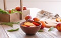 Bowl with fresh sliced peaches on wooden table Royalty Free Stock Photo