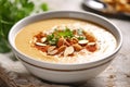 A bowl of fresh soup with broccoli and spicy chickpeas and grey kitchen towel