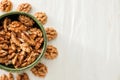 Bowl with fresh tasty walnuts on white wooden background Royalty Free Stock Photo