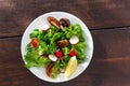 Bowl fresh vegetable salad on wooden table top view Royalty Free Stock Photo