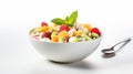 A bowl of fresh veggies and fruit in a healthy creamy green salad on a white background. Royalty Free Stock Photo