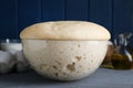 Bowl of fresh yeast dough on grey wooden table, closeup Royalty Free Stock Photo
