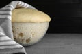 Bowl of fresh yeast dough on grey wooden table, closeup. Space for text Royalty Free Stock Photo