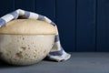 Bowl of fresh yeast dough on grey wooden table. Space for text Royalty Free Stock Photo