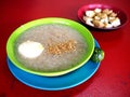 Bowl of freshly cooked rice porridge with egg and pork innards