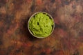 Bowl of freshly prepared fresh guacamole on a wooden background in brown tones. Healthy food rich in omega 3 fats that Royalty Free Stock Photo