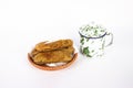 A bowl of fried bananas and small cup isolated on white background Royalty Free Stock Photo