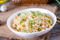 Bowl of fried rice, corn and egg on a wooden background. Healthy and light.