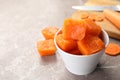 Bowl of frozen carrot puree cubes and ingredient on marble table, closeup. Space for text Royalty Free Stock Photo