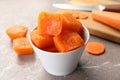 Bowl of frozen carrot puree cubes and ingredient on marble table, closeup Royalty Free Stock Photo