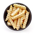 Bowl of frozen french fries isolated on white, from above