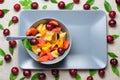 Bowl of fruit salad on rectangular plate. Royalty Free Stock Photo