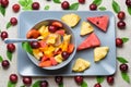 Bowl of fruit salad on rectangular plate. Royalty Free Stock Photo