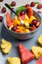 Bowl of fruit salad on rectangular plate. Royalty Free Stock Photo