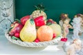 A bowl full of ceramic glazed fruits. Home interior decoration and design