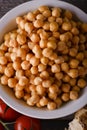 Bowl full of chickpeas on old wooden board