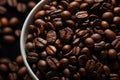 a bowl full of coffee beans on a black background