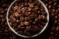 a bowl full of coffee beans on a black background
