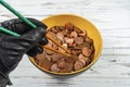 Bowl full of coins of the pound sterling and a hand holding chopsticks.Concept Royalty Free Stock Photo