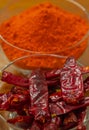 Bowl full of dry red chillies and red chilli powder Royalty Free Stock Photo
