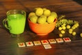 Bowl full with gooseberries, it`s juice, leaves, star gooseberries and label VITAMIN C