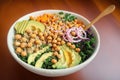 a bowl full of healty food, quinoa base, roasted sweet potatoes, steamed kale, fresh avocado