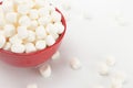 Bowl Full of Mini White Marshmallows on a White Background Royalty Free Stock Photo
