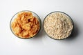 Bowl full of oats and corn flakes. Porridge oats in cereal bowl and corn flakes on white background. Royalty Free Stock Photo