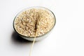 Bowl full of oats. Porridge oats in  cereal bowl on white background. A bowl of whole oats isolated on a white background. Royalty Free Stock Photo