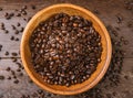 bowl full of organic coffee beans on old wooden table Royalty Free Stock Photo