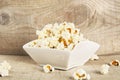 Bowl full of popcorn on wooden background Royalty Free Stock Photo