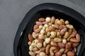 a bowl full of roasted hazelnuts, pistachios, cashews and a plate of various nuts Royalty Free Stock Photo