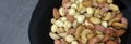 a bowl full of roasted hazelnuts, pistachios, cashews and a plate of various nuts Royalty Free Stock Photo