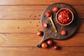 Bowl full of tomato sauce, Wooden spoon full of tomato sauce, spices, seasonings, Sliced ripe cherry tomato slices, Royalty Free Stock Photo