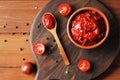 Bowl full of tomato sauce, Wooden spoon full of tomato sauce, spices, seasonings, Sliced ripe cherry tomato slices, Royalty Free Stock Photo