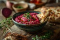 Bowl of garnished beetroot hummus and home baked Royalty Free Stock Photo