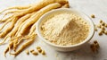 A bowl of ginseng root powder next to a pile of gingers Royalty Free Stock Photo
