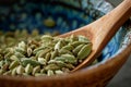 Bowl with grains cardamom detail of wooden spoon