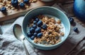 a bowl of granola, blueberries and milk