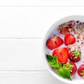 Bowl of granola with strawberries, textspace left, topview Royalty Free Stock Photo