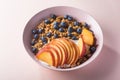 Bowl of granola with yogurt, peach slices and bluberry Royalty Free Stock Photo