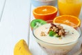 Bowl of granola with youghurt and sliced fruits