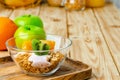 Bowl of granola with youghurt and sliced fruits